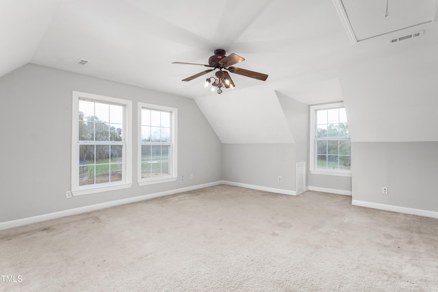 additional living space featuring attic access, carpet flooring, baseboards, visible vents, and a ceiling fan
