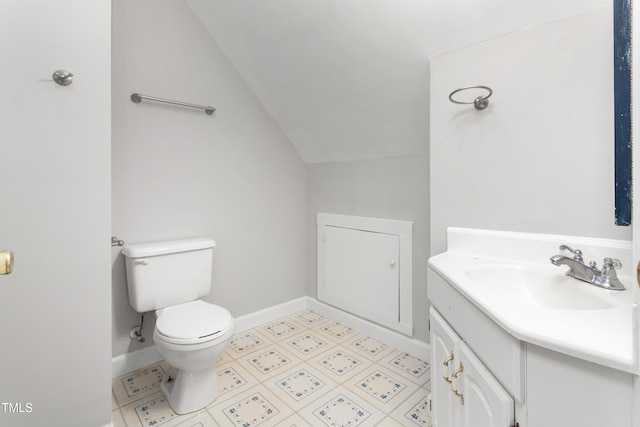 half bath featuring baseboards, lofted ceiling, toilet, and vanity