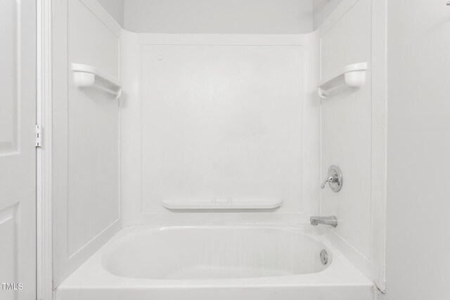 bathroom with bathing tub / shower combination