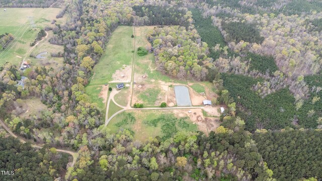 birds eye view of property with a forest view