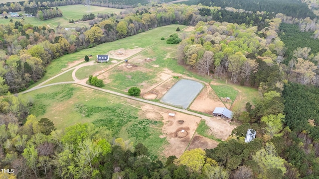 birds eye view of property with a view of trees and a rural view
