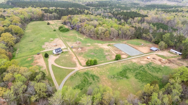 drone / aerial view with a wooded view