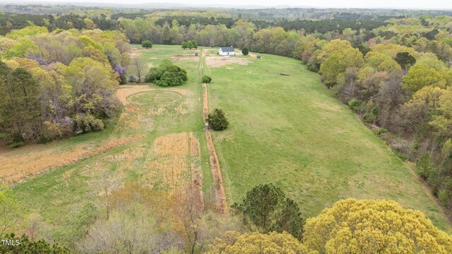 drone / aerial view with a forest view and a rural view