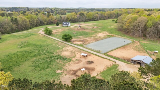 birds eye view of property featuring a forest view and a rural view