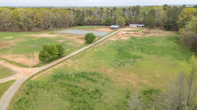 drone / aerial view featuring a rural view and a forest view