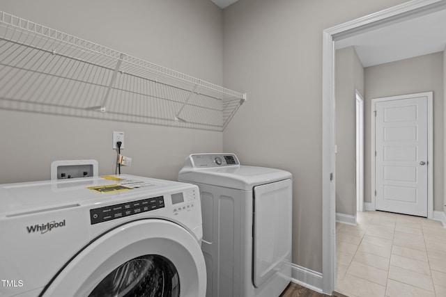 381 Heart Pine Dr, Wendell, NC 27591 - clothes washing area featuring independent washer and dryer, light tile patterned flooring, baseboards, and laundry area