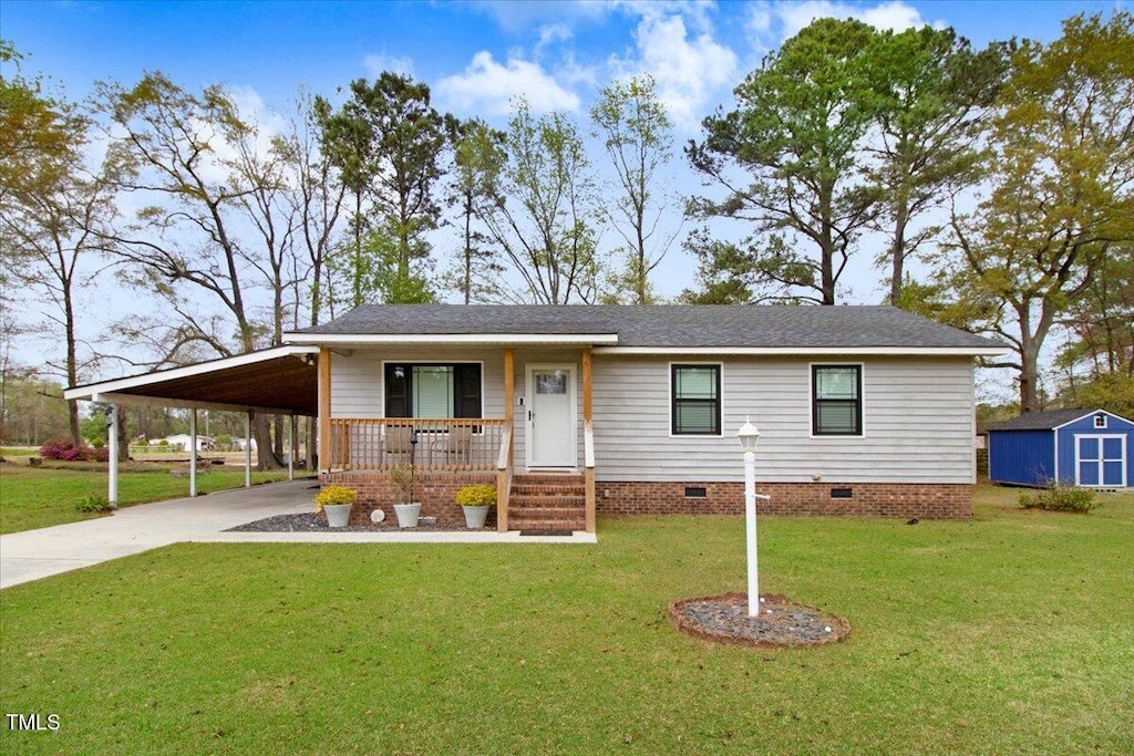 view of front of home featuring driveway, covered porch, an attached carport, an outdoor structure, and crawl space
