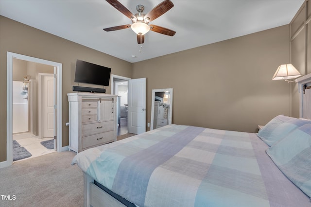 bedroom featuring light colored carpet and connected bathroom
