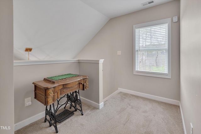 interior space featuring visible vents, carpet floors, baseboards, and lofted ceiling