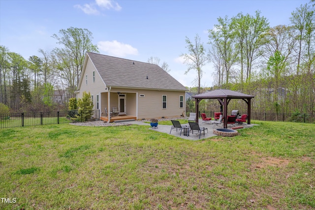 rear view of house featuring a patio area, a gazebo, fence private yard, and a lawn