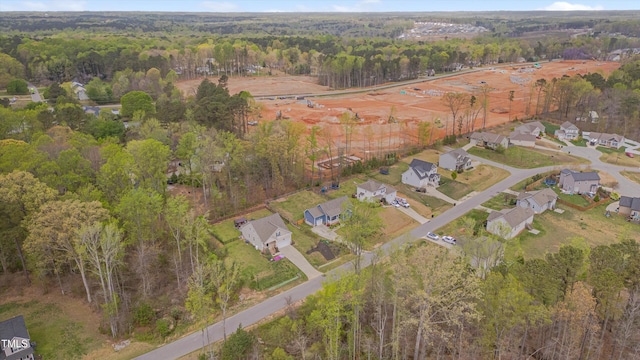 aerial view with a wooded view and a residential view