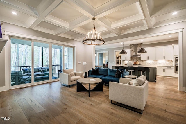 living area with coffered ceiling, a notable chandelier, light wood-style flooring, beamed ceiling, and recessed lighting
