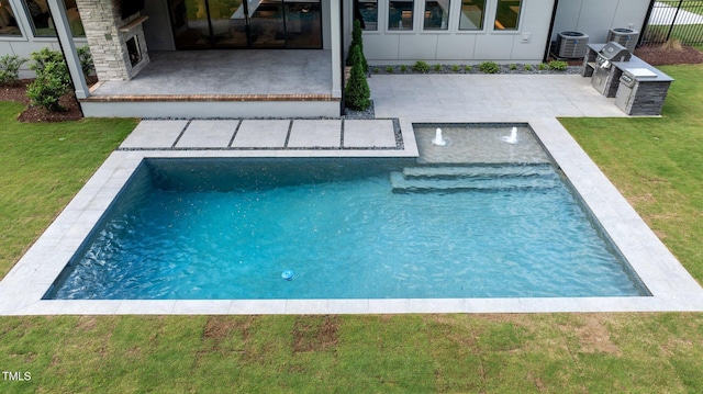 pool featuring a yard, a patio, and central AC
