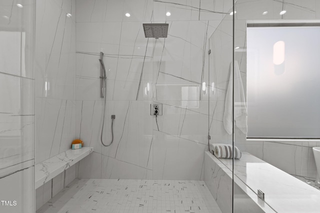 full bath with tile walls and a marble finish shower