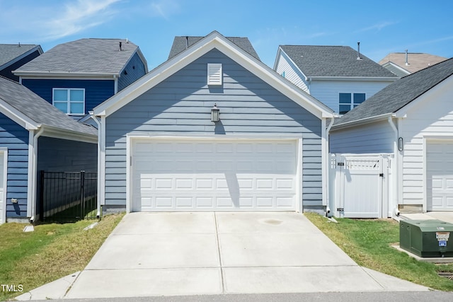 view of front of house featuring driveway, a gate, and a garage