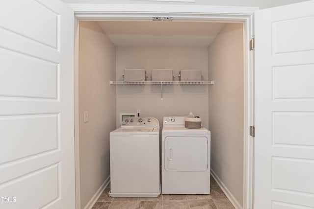 laundry area featuring washer and clothes dryer and baseboards