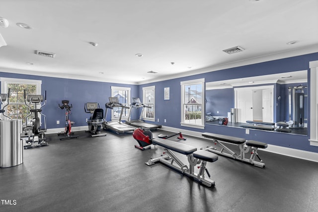 gym with baseboards and crown molding