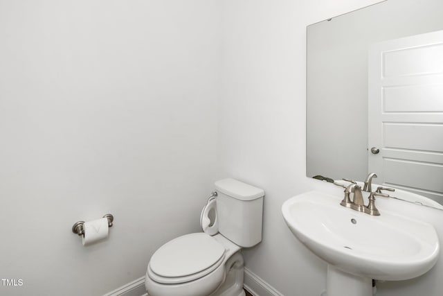 2129 Mars Hill Ln, Apex, NC 27502 - half bath with a sink, toilet, and baseboards
