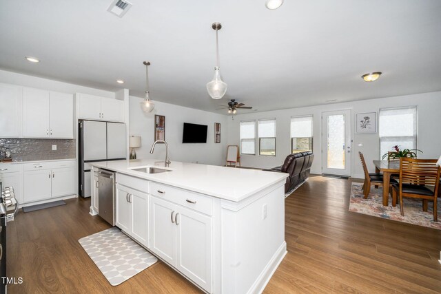 2129 Mars Hill Ln, Apex, NC 27502 - kitchen with stainless steel dishwasher, freestanding refrigerator, visible vents, a sink, and dark wood-style floors