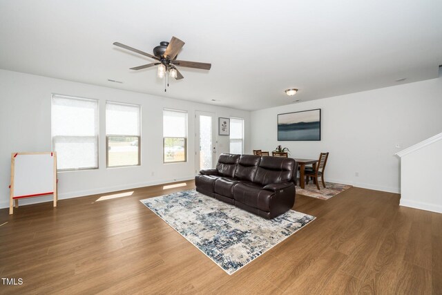 2129 Mars Hill Ln, Apex, NC 27502 - living room with wood finished floors, baseboards, and a ceiling fan