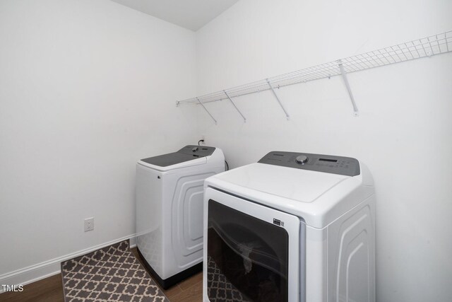 2129 Mars Hill Ln, Apex, NC 27502 - laundry area featuring dark wood-type flooring, baseboards, washing machine and dryer, and laundry area