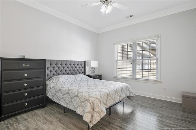 bedroom featuring baseboards, ornamental molding, visible vents, and wood finished floors