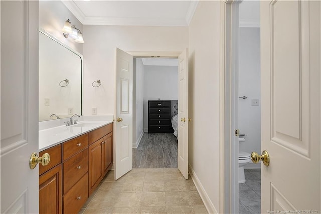 full bath with crown molding, baseboards, toilet, vanity, and tile patterned flooring