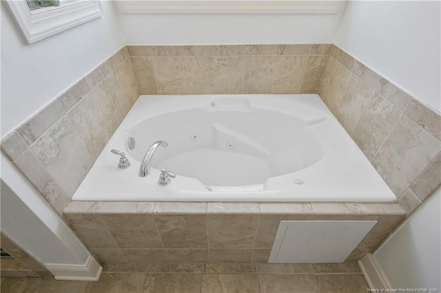 full bath with a tub with jets and tile patterned flooring