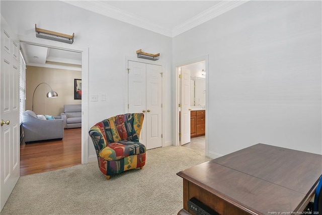 sitting room featuring crown molding, baseboards, and light colored carpet