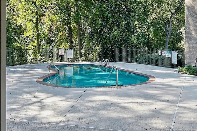 view of pool with a pool, fence, and a patio