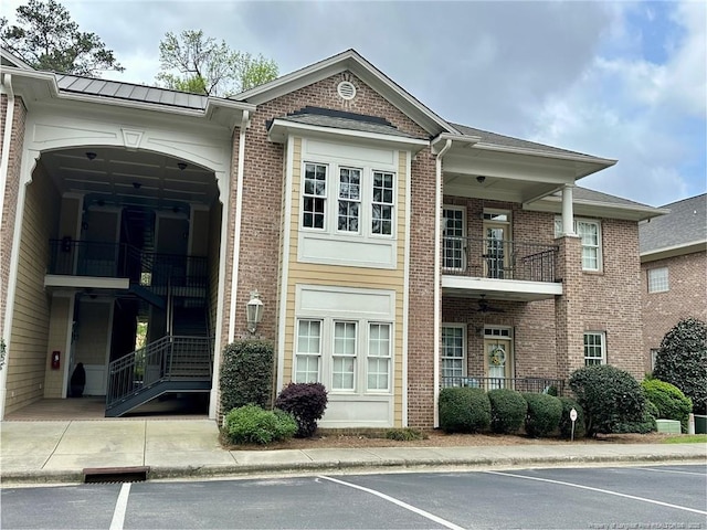 view of building exterior featuring uncovered parking