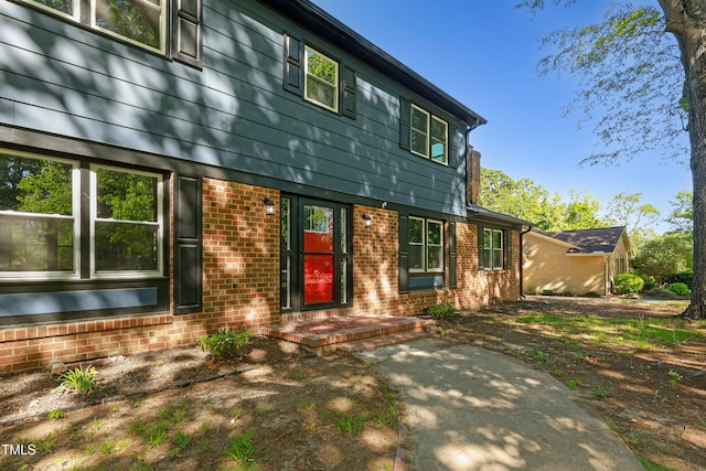 rear view of house with brick siding