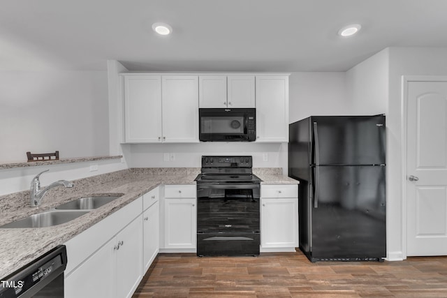 918 E Green St Unit F105, Franklinton, NC 27525 - kitchen with light stone counters, black appliances, white cabinetry, and a sink