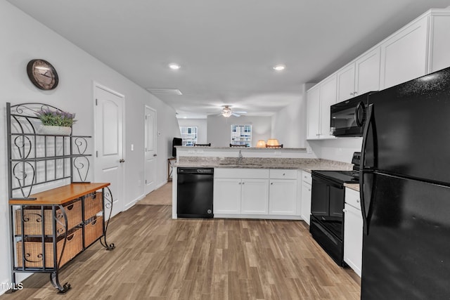 918 E Green St Unit F105, Franklinton, NC 27525 - kitchen with white cabinets, a peninsula, a sink, ceiling fan, and black appliances