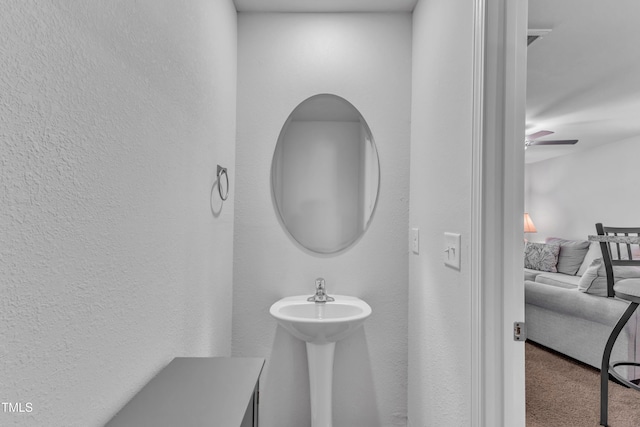 918 E Green St Unit F105, Franklinton, NC 27525 - bathroom featuring a textured wall, a sink, and ceiling fan