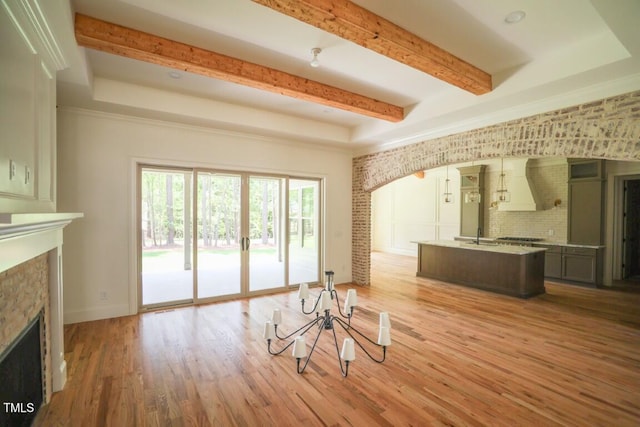 1212 Perry Bluff Dr, Wake Forest, NC 27587 - living area featuring a fireplace, light wood-type flooring, beamed ceiling, and arched walkways