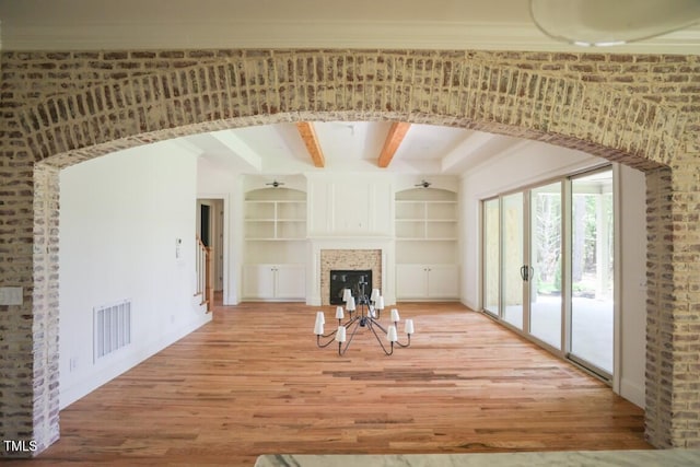 1212 Perry Bluff Dr, Wake Forest, NC 27587 - unfurnished living room with wood finished floors, built in features, and beamed ceiling