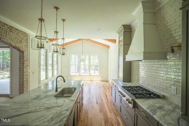 1212 Perry Bluff Dr, Wake Forest, NC 27587 - kitchen with stainless steel gas stovetop, backsplash, light wood finished floors, light stone countertops, and crown molding