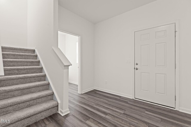825 Kenyon Spring Dr, Zebulon, NC 27597 - entryway featuring baseboards, stairs, and dark wood-style floors