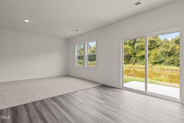 825 Kenyon Spring Dr, Zebulon, NC 27597 - spare room with visible vents, baseboards, recessed lighting, and wood finished floors