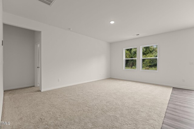 825 Kenyon Spring Dr, Zebulon, NC 27597 - spare room featuring recessed lighting, carpet, visible vents, and baseboards