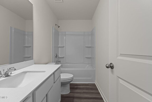 825 Kenyon Spring Dr, Zebulon, NC 27597 - bathroom featuring visible vents, toilet, vanity, wood finished floors, and shower / bathtub combination