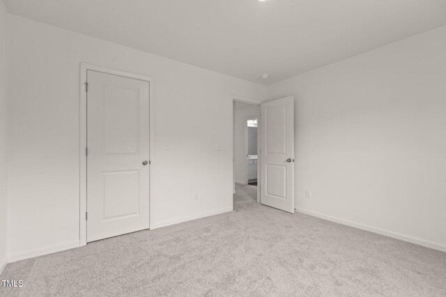 825 Kenyon Spring Dr, Zebulon, NC 27597 - unfurnished bedroom featuring baseboards and carpet