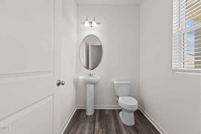 825 Kenyon Spring Dr, Zebulon, NC 27597 - half bathroom featuring toilet, wood finished floors, and baseboards