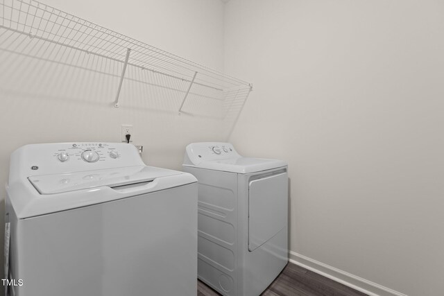 825 Kenyon Spring Dr, Zebulon, NC 27597 - washroom featuring independent washer and dryer, dark wood-style flooring, laundry area, and baseboards