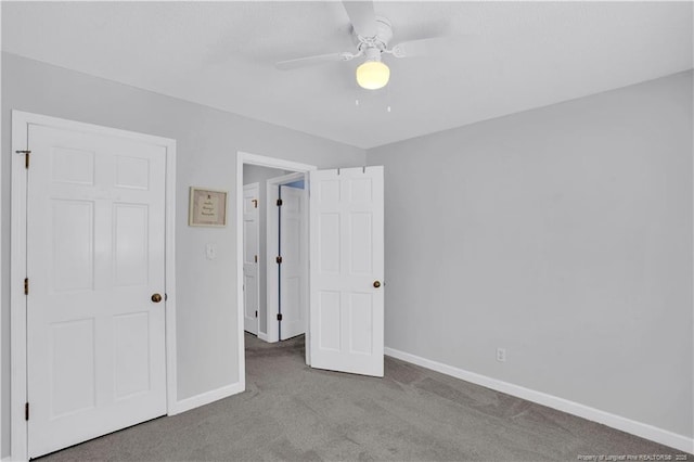 unfurnished bedroom with baseboards, carpet, and a ceiling fan