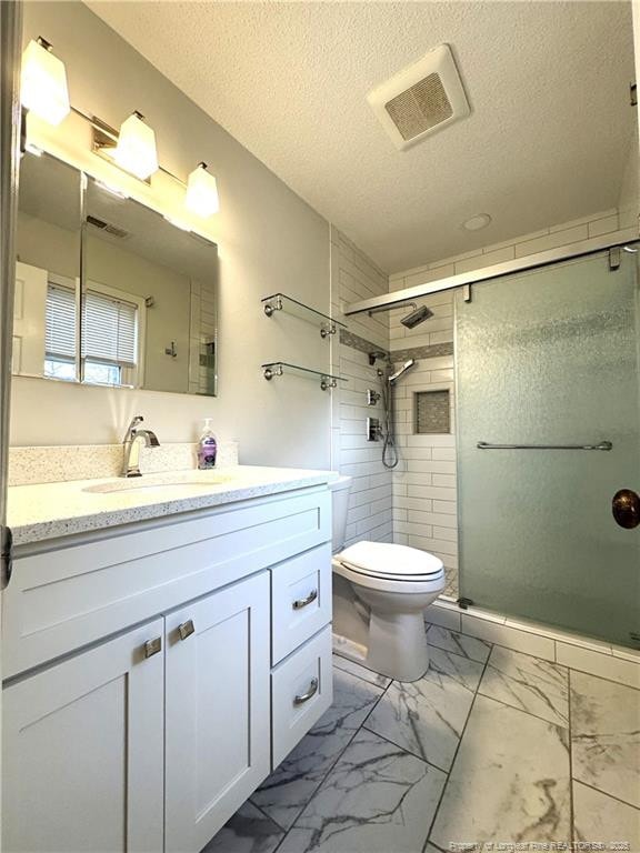 bathroom with marble finish floor, visible vents, toilet, and a shower stall
