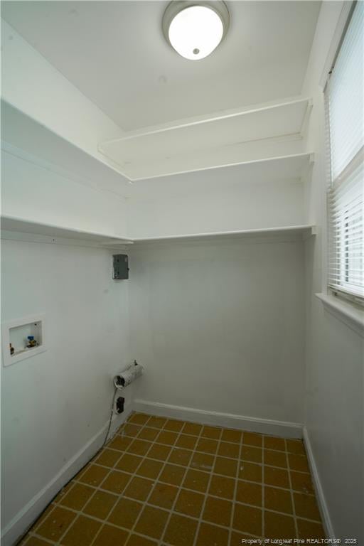 washroom featuring tile patterned floors, baseboards, laundry area, and washer hookup