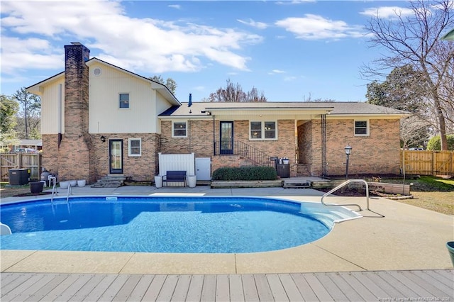 view of swimming pool with central air condition unit, fence, a patio, a water slide, and a fenced in pool