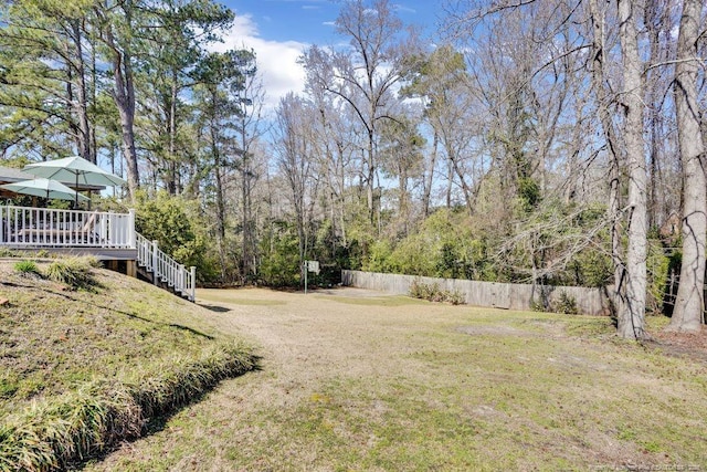 view of yard featuring stairway, fence, and a wooden deck